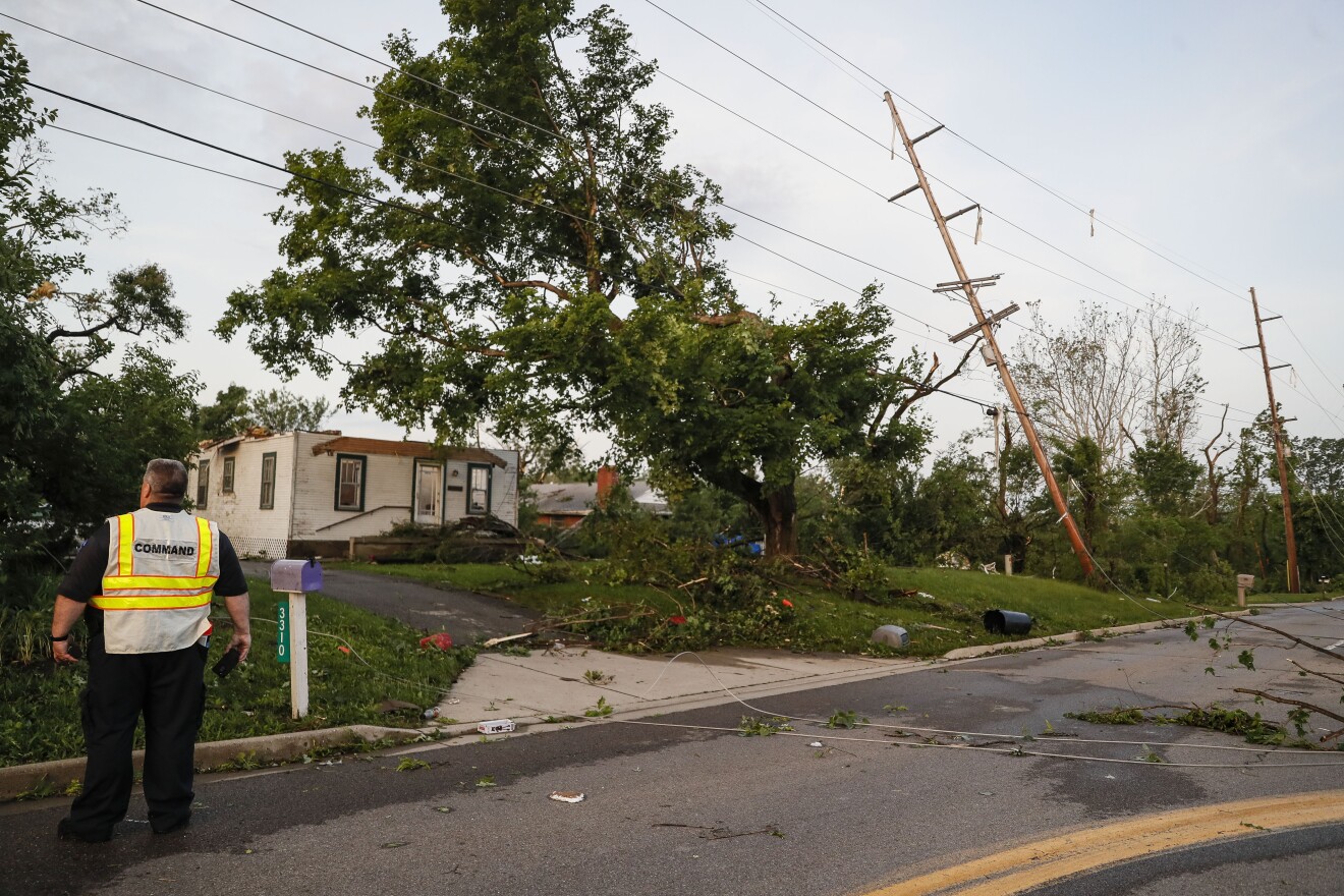 Storm damage litters a residential neighborhood Tuesday, May 28, in Vandalia, Ohio. A rapid-fire line of apparent tornadoes tore across Indiana and Ohio overnight, packed so closely together that one crossed the path carved by another. 